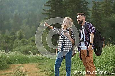 Couple navigate with smart phone while hiking Stock Photo