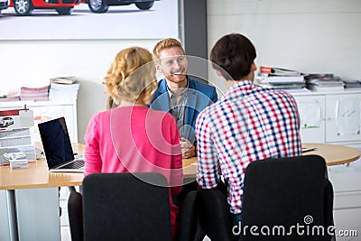 Couple negotiating sale contract for car Stock Photo