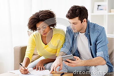 Couple with papers and calculator at home Stock Photo