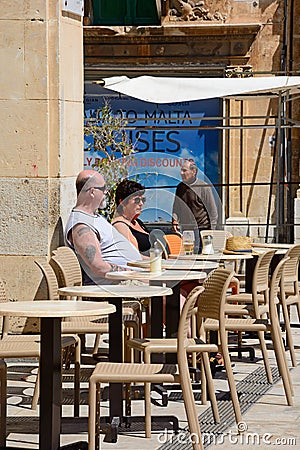 Couple at a pavement cafe, Valletta. Editorial Stock Photo