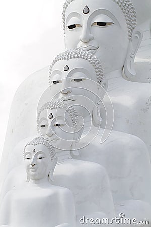 Couple peaceful white buddha statues sitting well alignment and decorating wonderful attractive mirror Stock Photo