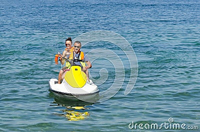 Couple people having fun with Jetski on open sea Stock Photo