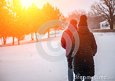 A couple of people walk in the winter Park Stock Photo