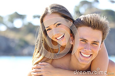 Couple with perfect smile posing on the beach Stock Photo