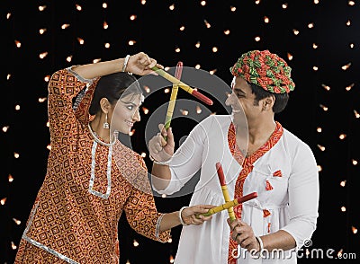 Couple performing Dandiya Raas on Navratri Stock Photo