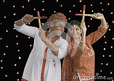 Couple performing Dandiya Raas on Navratri Stock Photo