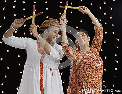 Couple performing Dandiya Raas on Navratri Stock Photo