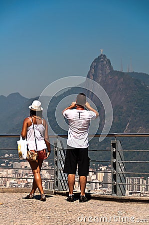 Couple photographing Christ the Redeemer in Rio de Janeiro, Brazil Editorial Stock Photo