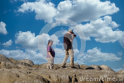 Couple Photographing on Rocks Editorial Stock Photo