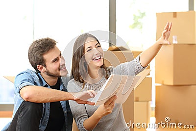 Couple planning decoration when moving home Stock Photo