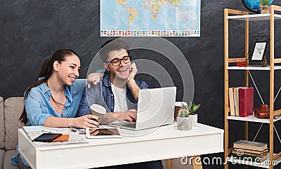 Couple planning trip, browsing on laptop at home Stock Photo