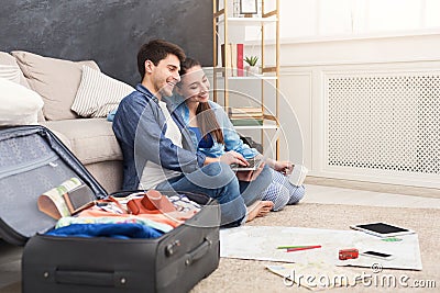 Couple planning trip, browsing on laptop at home Stock Photo