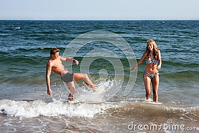 Couple playing in beach water Stock Photo