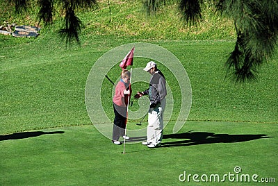 Couple playing golf, Spain. Editorial Stock Photo