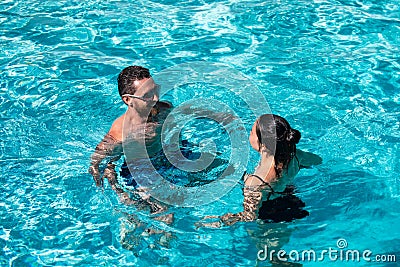 Couple in pool. Summer pool resort. Life winner. Butt in bikini. Pool party. Stock Photo