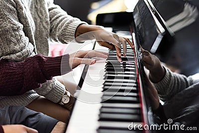 Couple practicing on a piano together Stock Photo