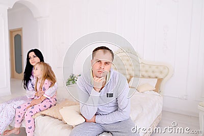 Couple quarrel and child upset, sitting bed in white interior Stock Photo