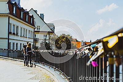 Couple at the railing with many padlocks attached Editorial Stock Photo