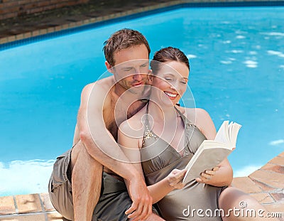 couple-reading-book-swimming-pool-184558