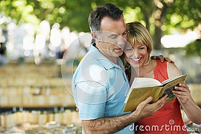 Couple Reading Guidebook Stock Photo