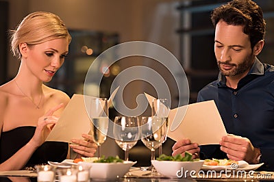 Couple reading menu at restaurant Stock Photo