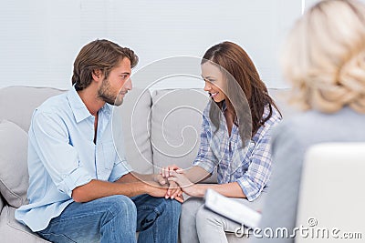 Couple reconciling on the couch Stock Photo