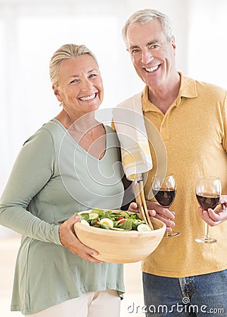 Couple With Red Wineglass And Salad At Home Stock Photo