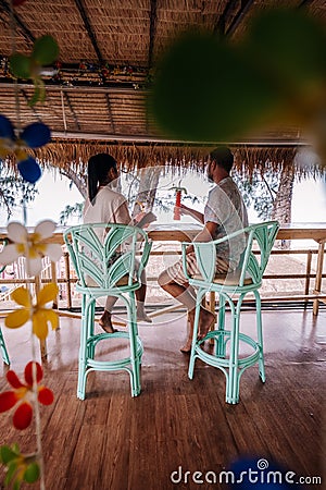 Couple relax on the beach in Pattaya Thailand Jomtien beach with beach clubs and restaurants Stock Photo