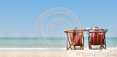 Couple relaxing on chair beach over sea background Stock Photo