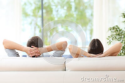 Couple relaxing on a couch at home Stock Photo