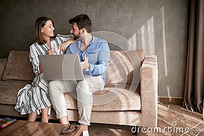 Couple relaxing on sofa with laptop. Love, happiness, people and Stock Photo