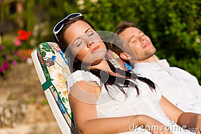 Couple resting in deck chair in summer Stock Photo