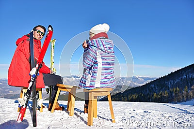 A couple is resting on lounges in picnic zone on european ski resort Stock Photo