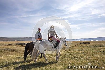 Coupleriding mongolian horses Stock Photo