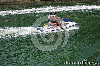 Couple riding a personal watercraft Editorial Stock Photo