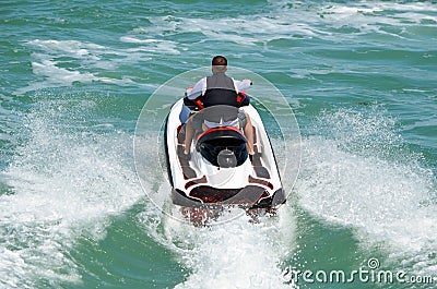 Couple riding Tandem on a Speeding Jet Ski. Editorial Stock Photo