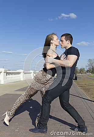 A couple roundly dancing on the brick road Stock Photo