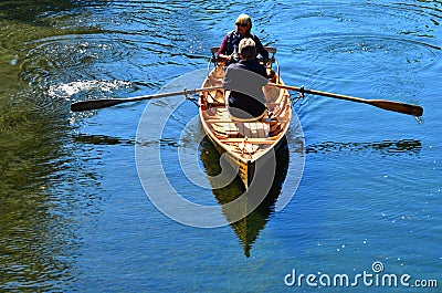 Couple Rowing row boat over Avon River Christchurch - New Zealand Editorial Stock Photo