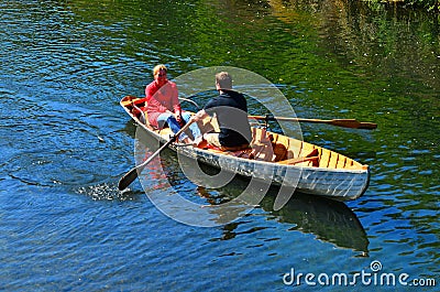 Couple Rowing row boat over Avon River Christchurch - New Zealand Editorial Stock Photo