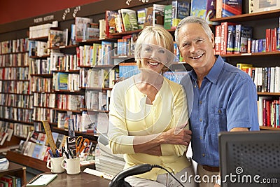 Couple running bookshop Stock Photo