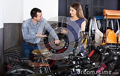 Couple selecting bikes at rental agency Stock Photo