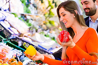 Couple selecting vegetables in hypermarket Stock Photo