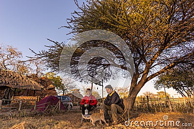 Couple selfie having breakfast, camping outdoors, morning cold. Travel adventure in Kruger National Park, South Africa. Stock Photo