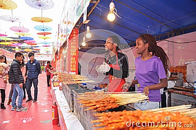 A couple selling grilled lamb kebab on food street Editorial Stock Photo