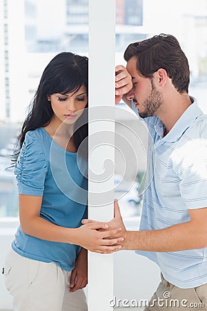 Couple are separated by white wall Stock Photo