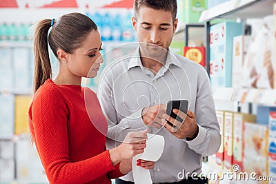 Couple shopping and checking a receipt Stock Photo