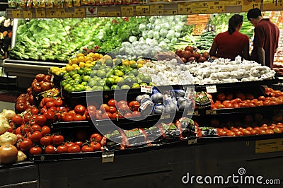 Couple shopping in the fruit and vegetable section of a store Editorial Stock Photo