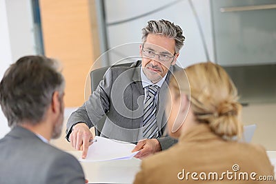 Couple signing contract in lawyer's office Stock Photo