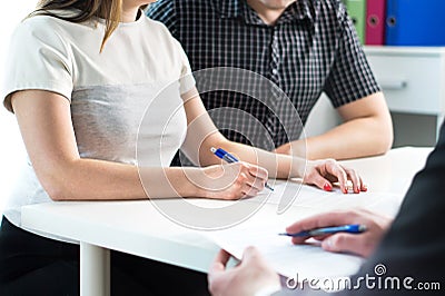 Couple signing contract. Legal document, health insurance. Stock Photo