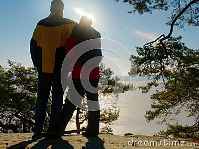 Couple silhouette. Young pair in winter walk against sun Stock Photo